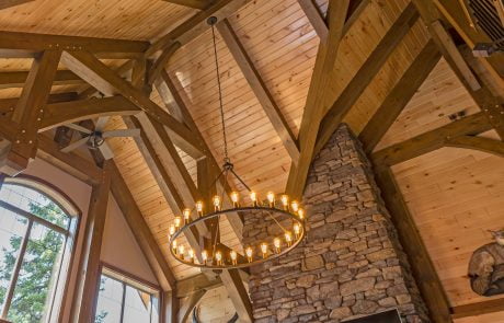 View of ceiling beams and stone fireplace