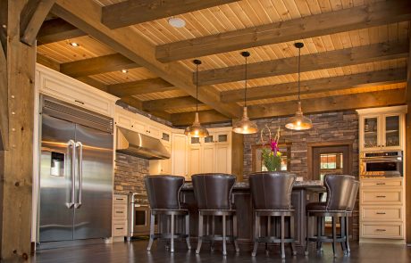 Kitchen with cream cabinets and dark wood island.