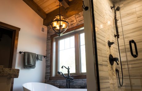 Bathroom with tile shower and free standing tub.