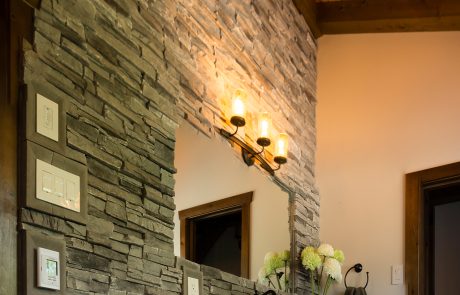 White bathroom vanity with marbled stone countertop.