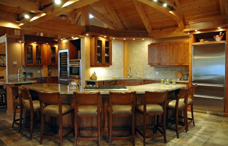 Kitchen with large island that seats 8. Tile floor and wood cabinets.