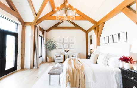 bedroom with wood accent beams.