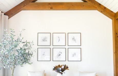 Bedroom sitting nook with wood accent beams on white ceiling and walls.