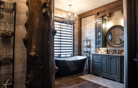 Bathroom with dark cabinets and dark wood flooring