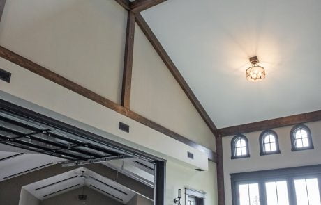 Large garage, view from interior of trim work and windows. Two white vehicles