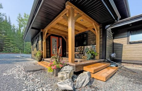Exterior entrance with contrasting lighter wood color in entry and darker siding.