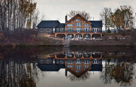 Home exterior with reflection of home on the lake