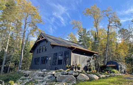 Cabin exterior - dark grey with medium wood trim accents.