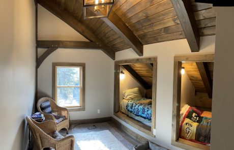 Loft with two single beds built into the angled wall